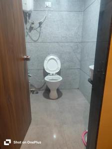 a bathroom with a toilet and a sink at Hotel VR Villa in Vadodara