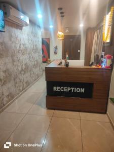 a reception desk in a room with a kitchen at Hotel VR Villa in Vadodara