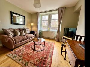 a living room with a couch and a table at Bed on the Brae in Inverness