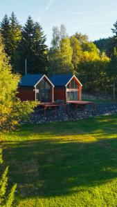 a cabin in the middle of a field with trees at Domki na polanie in Stryszawa +17 photos