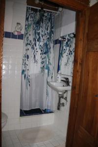 a bathroom with a sink and a shower curtain at B&B Montiju in Ozieri