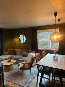a living room with a couch and a table at Cabin in Valldalen, Røldal in Røldal