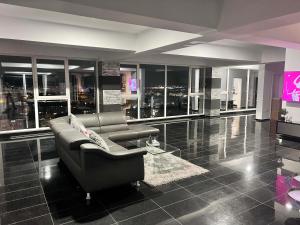 a large living room with a couch and a television at Sky17 Penthouse Sibiu in Şelimbăr