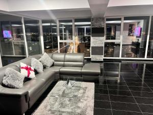 a living room with a couch and a city skyline at Sky17 Penthouse Sibiu in Şelimbăr +19 photos