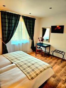 a bedroom with a bed and a table and a window at Chalet Du Centre in Aosta +20 photos