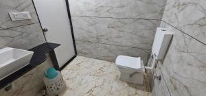 a bathroom with a toilet and a sink at HOTEL MAHER Inn in Ahmedabad