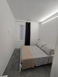 een kleine slaapkamer met een bed en een raam bij DANITO Rooms 7 in Ancona