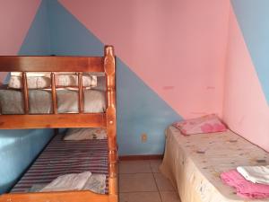 a bedroom with two bunk beds in a attic at Pousada da Rita in Nova Friburgo