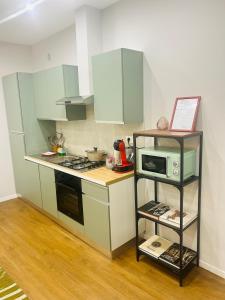 a small kitchen with a microwave and a stove at AB apartment Pistoia in Pistoia