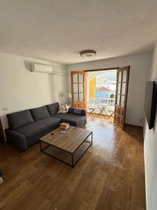 a living room with a couch and a coffee table at Jurgita Apartment in Los Llanos de Aridane