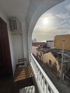 a balcony with a wooden bench on a building at Jurgita Apartment in Los Llanos de Aridane