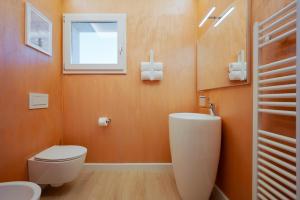 a bathroom with a toilet and a sink and a mirror at NEW Casa Florentia in Ambrogiana