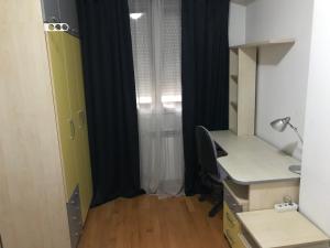 an office with a desk and a chair and a window at First Choice Apartment in Skopje +17 photos
