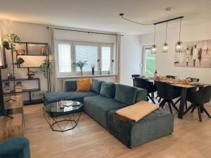 a living room with a couch and a table at Allgäu Retreat in Bad Wörishofen