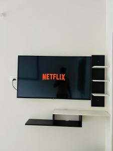 a flat screen tv sitting on top of a shelf at Pritam Homestay in Hubli