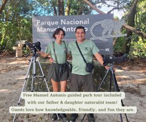 a man and woman standing in front of a camera at Mi Zaru Sea View Hotel Free Park Tour & Breakfast in Manuel Antonio
