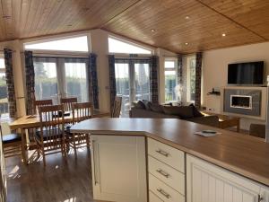 Field View 2 bed-No pets-Hornbeam في Horham: مطبخ وغرفة معيشة مع أريكة وطاولة