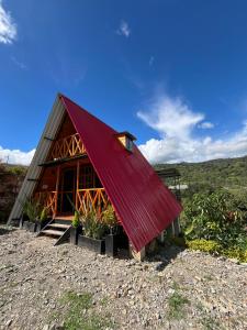 a barn with a red roof on a hill at Cabaña El Resguardo in La Capilla +17 photos