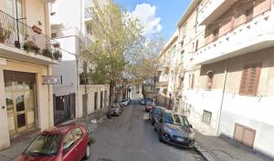 a street with cars parked on the sides of buildings at DaMaky in Reggio di Calabria