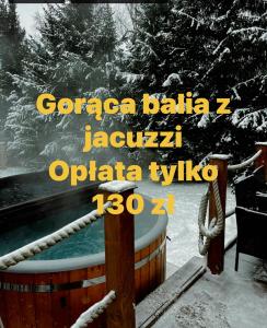 a sign for a hot tub in the snow at Gypsy Hill & Spa in Międzylesie