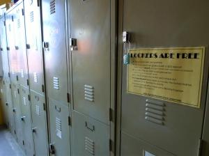 a row of lockers with a sign that reads toilets are fire at Betel Box Backpackers Hostel in Singapore