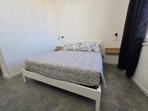 a bedroom with a bed with a gray comforter at Danito Rooms 5 matrimoniale in Ancona