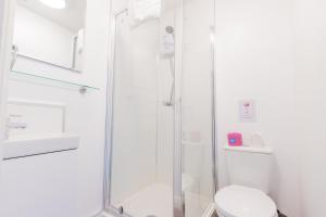 a white bathroom with a shower and a toilet at New Street C - City Centre in Worcester