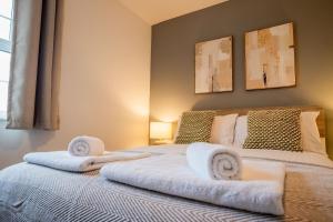 a bedroom with a bed with towels on it at New Street C - City Centre in Worcester