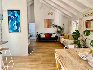 a living room with a table and a couch at Tairua Tides - Relaxed Coastal Retreat in Tairua +17 photos