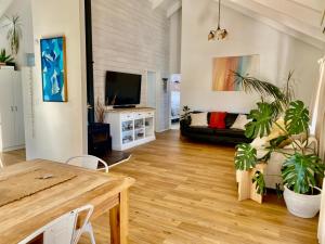 a living room with a table and a couch at Tairua Tides - Relaxed Coastal Retreat in Tairua