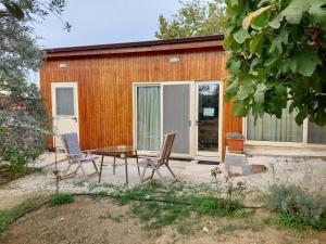 a patio with a table and chairs in front of a building at Pervolaris Cottages 1 in Goudhi +65 photos
