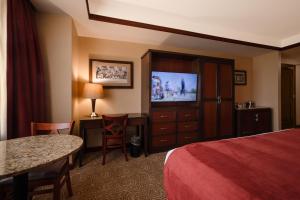 a hotel room with a bed and a flat screen tv at Downstream Casino Resort in Loma Linda
