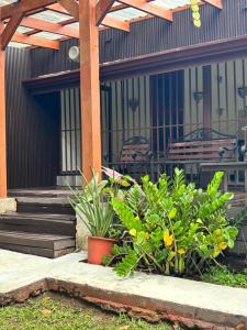 a patio with benches and plants in front of a building at Casa Mas in Escobal