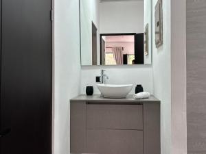 a bathroom with a sink and a mirror at Residencial de montaña Los Quetzales in Poás +67 photos