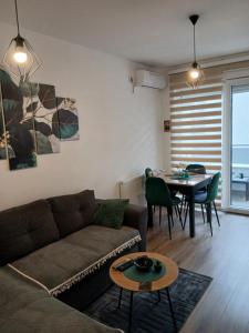 a living room with a couch and a table at Tri srca in Banja Koviljača