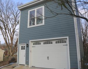 a blue house with a white garage door at Charming Carriage House in NE Washington DC in Washington