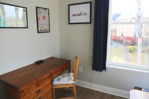 a bedroom with a wooden dresser and a window at Charming Carriage House in NE Washington DC in Washington
