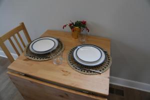 a table with plates and glasses on top of it at Charming Carriage House in NE Washington DC in Washington +3 photos
