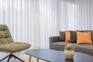 a living room with a couch and a coffee table at Sunflower Gem by Homie in Caniço
