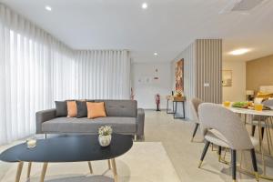 a living room with a couch and a table at Sunflower Gem by Homie in Caniço +15 photos
