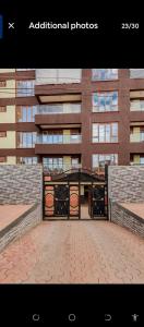 a picture of a building with a brick walkway at 2bedroom house along waiyaki way in Nairobi