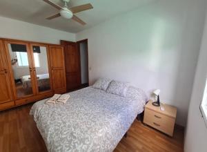 a bedroom with a bed and a ceiling fan at Jurgita Apartment in Los Llanos de Aridane