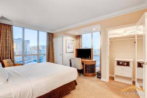 a hotel room with a bed and a television at MGM Signature-09-821 1Br2Ba F1 Strip View Balcony Suite in Las Vegas