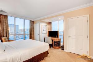 a hotel room with a bed and a television at MGM Signature-09-821 1Br2Ba F1 Strip View Balcony Suite in Las Vegas