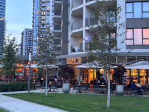 a building with people sitting at tables in a park at GIGI Apartment in Belgrade