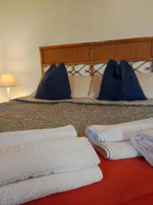 a bedroom with a bed with towels on it at Torre Cà Emo, CasAmarti in Vittorio Veneto