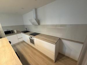 a kitchen with white cabinets and a counter top at Compleks by Karlus in Jelgava
