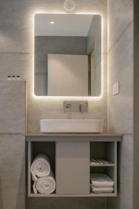 a bathroom with a sink and a mirror at Aceotel Premier Ujjayanta, Ujjain in Ujjain
