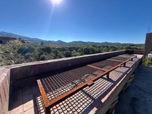 a group of benches sitting on top of a building at Punta El Tesoro - Playa Privada al Lago in Potrero de los Funes