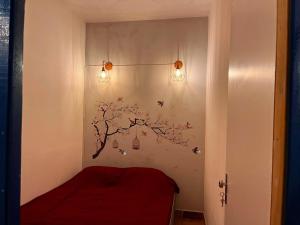 a bedroom with a tree on the wall with lights at Canto do Florescer in Pesqueira